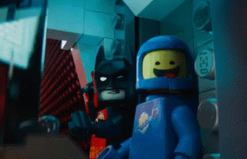 Lego Batman throws many weapons at a button. Hits it. Says "first try"
